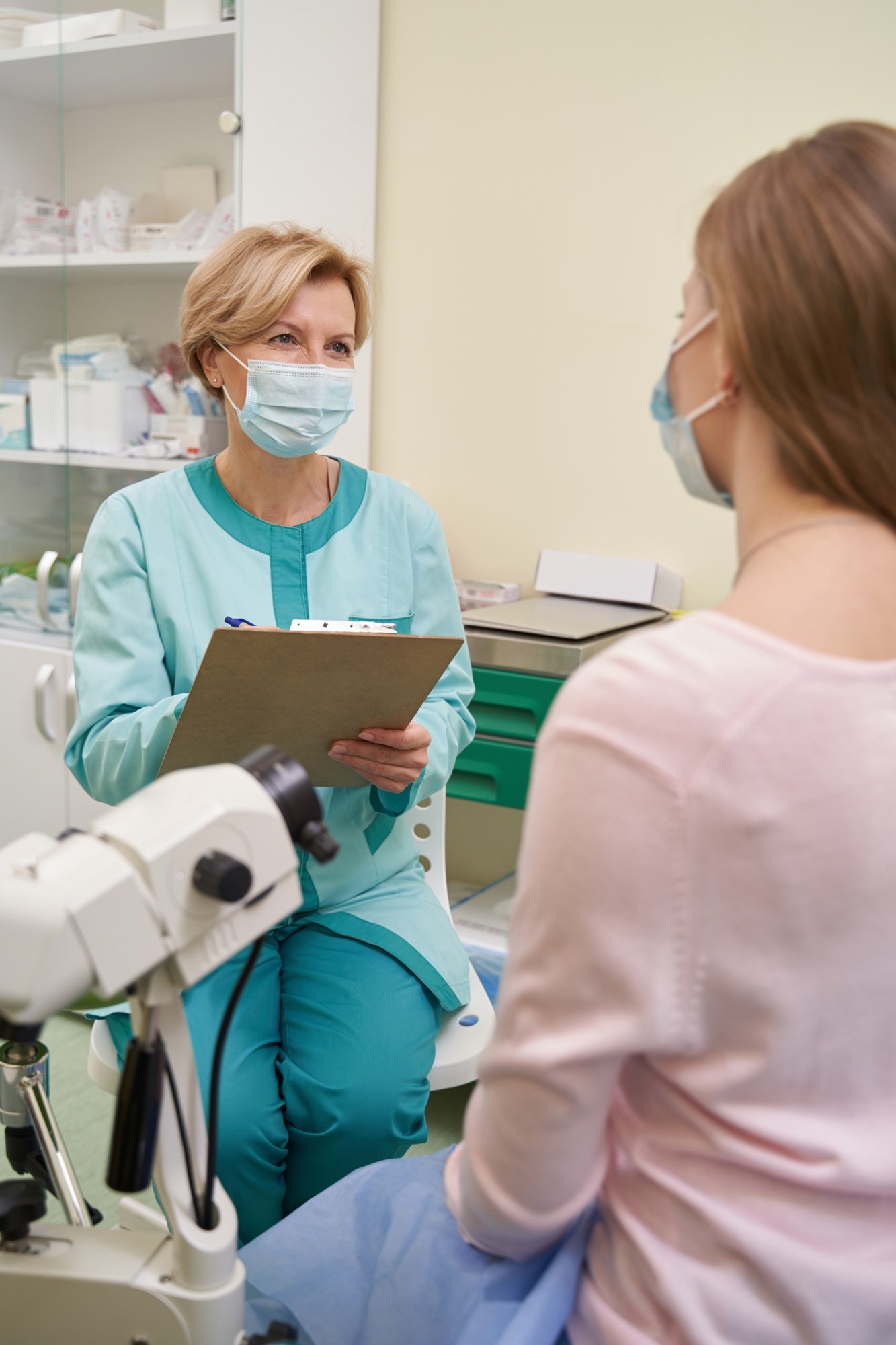 Professional medical worker consulting her young patient